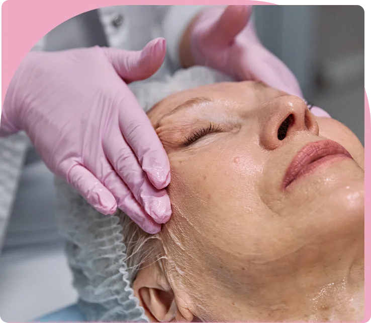 A woman getting her face waxed at the salon