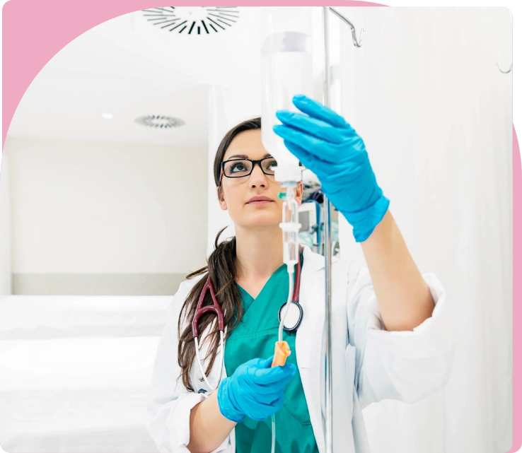 A woman in blue gloves holding a toothbrush.