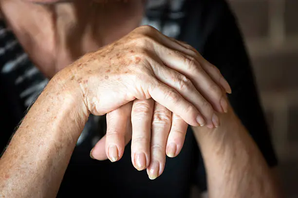 A close up of two hands holding each other